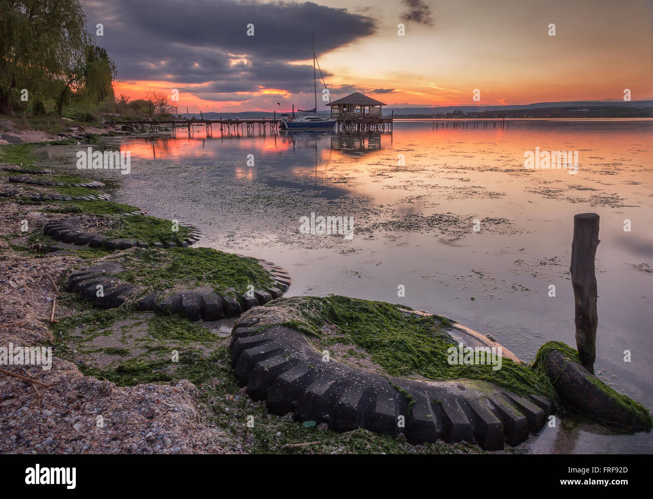 Beautiful Sunset View With Tires And Old Fisherman Cottage On The