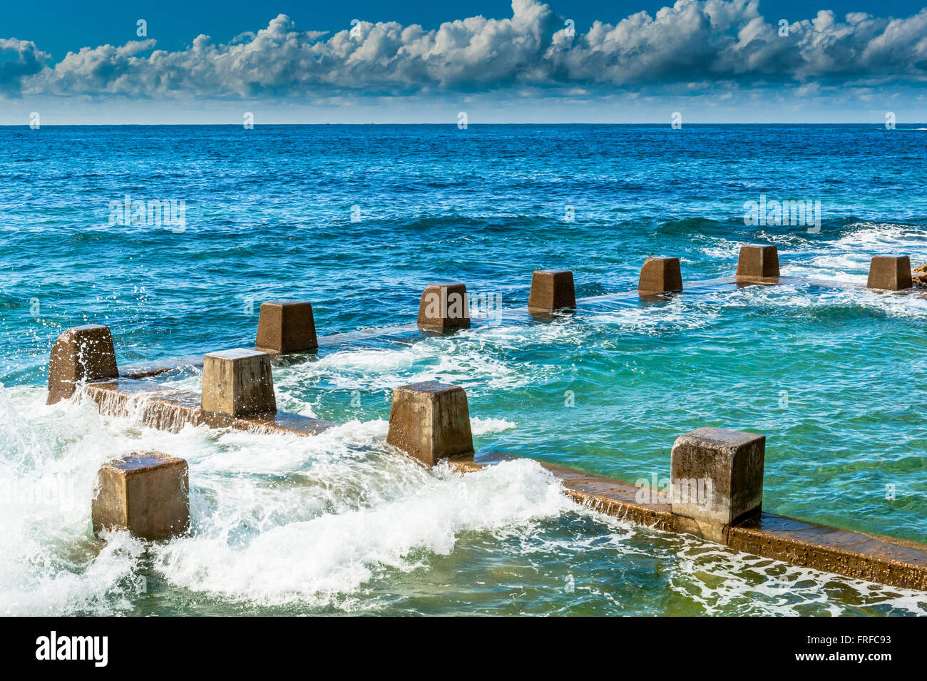 Early morning swimmers at the outdoor rock pool at Coogee Beach Sydney New South Wales Australia Stock Photo