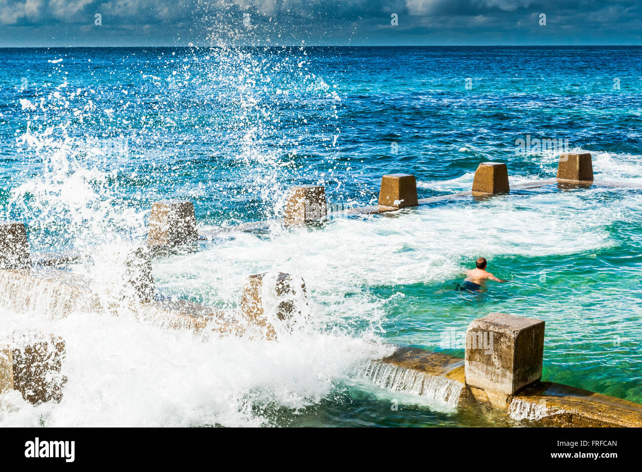 Early morning swimmers at the outdoor rock pool at Coogee Beach Sydney New South Wales Australia Stock Photo