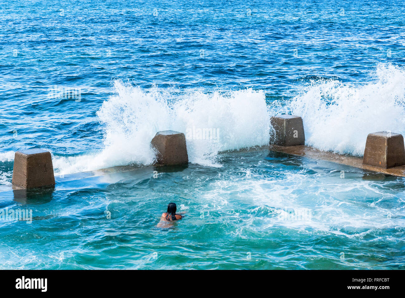 Early morning swimmers at the outdoor rock pool at Coogee Beach Sydney New South Wales Australia Stock Photo