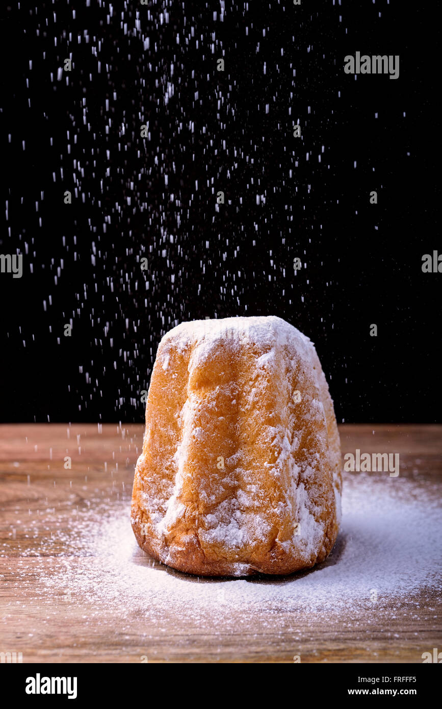 pandoro cake with icing sugar on wood traditional dessert in Italy for christmas Stock Photo
