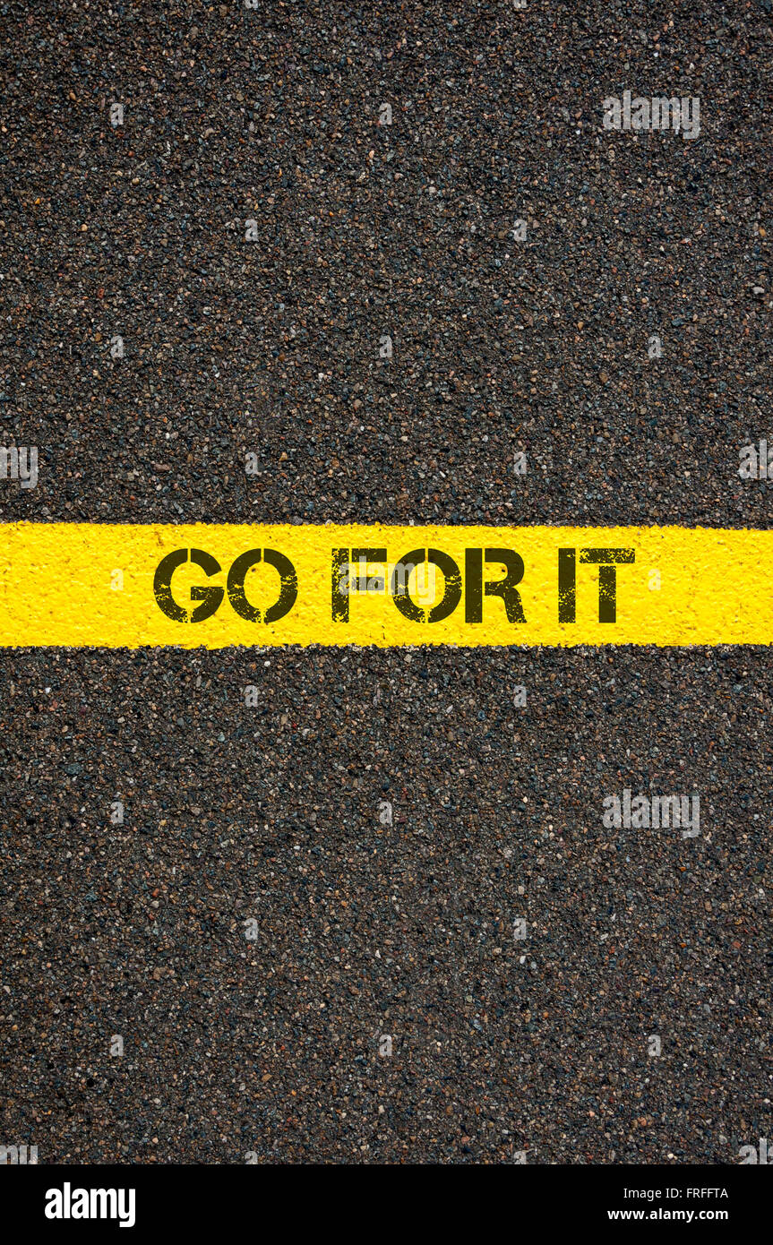 Road marking yellow paint dividing line with words GO FOR IT, concept