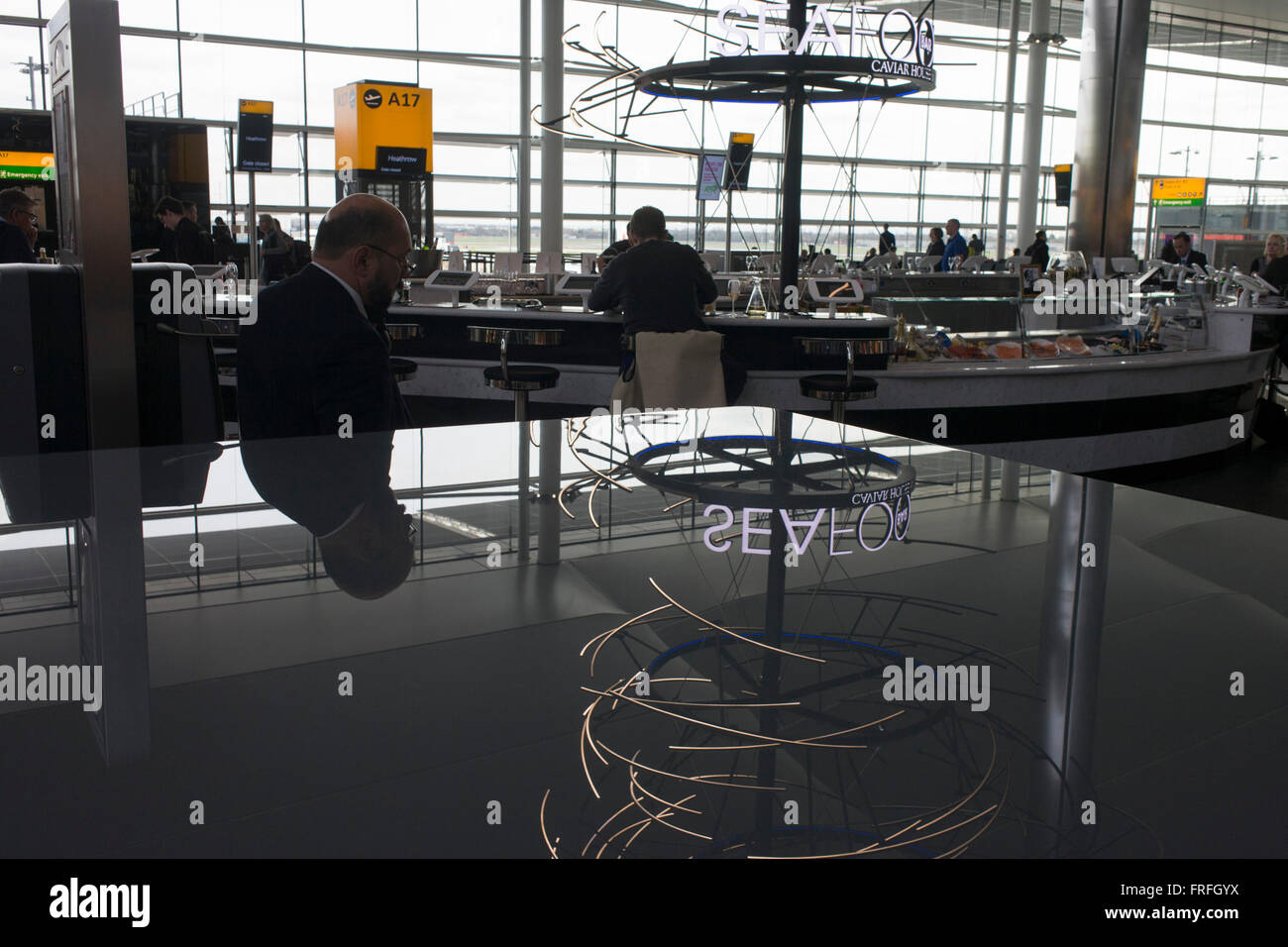 Passengers and Heathrow airport terminal 2 design. Stock Photo
