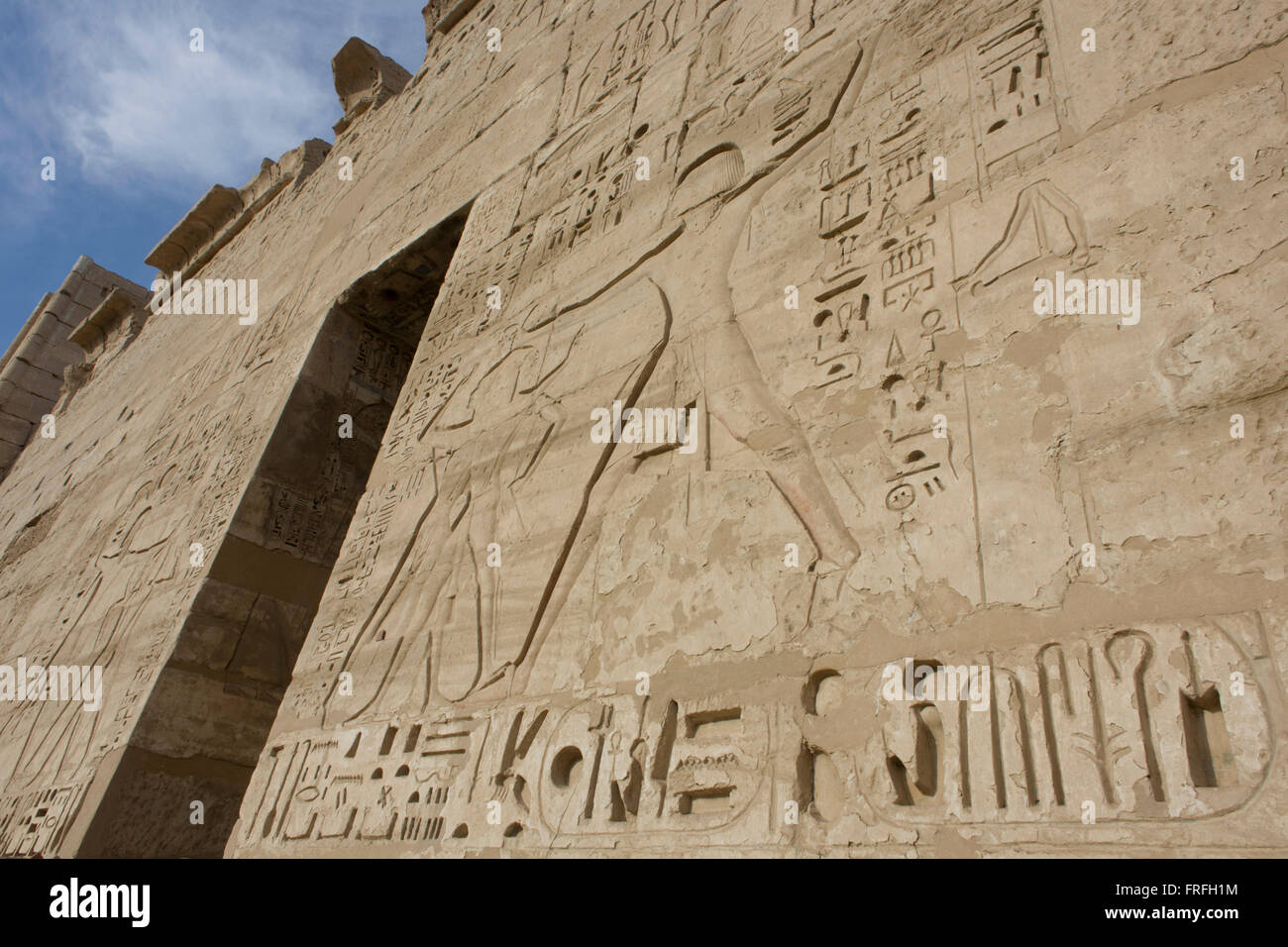 Hieroglyphs on the first pylon at the ancient Egyptian site of Medinet Habu (1194-1163BC), the Mortuary Temple of Ramesses III in Luxor, Nile Valley, Egypt. Medinet Habu is an important New Kingdom period structure in the West Bank of Luxor in Egypt. Aside from its size and architectural and artistic importance, the temple is probably best known as the source of inscribed reliefs depicting the advent and defeat of the Sea Peoples during the reign of Ramesses III. Stock Photo