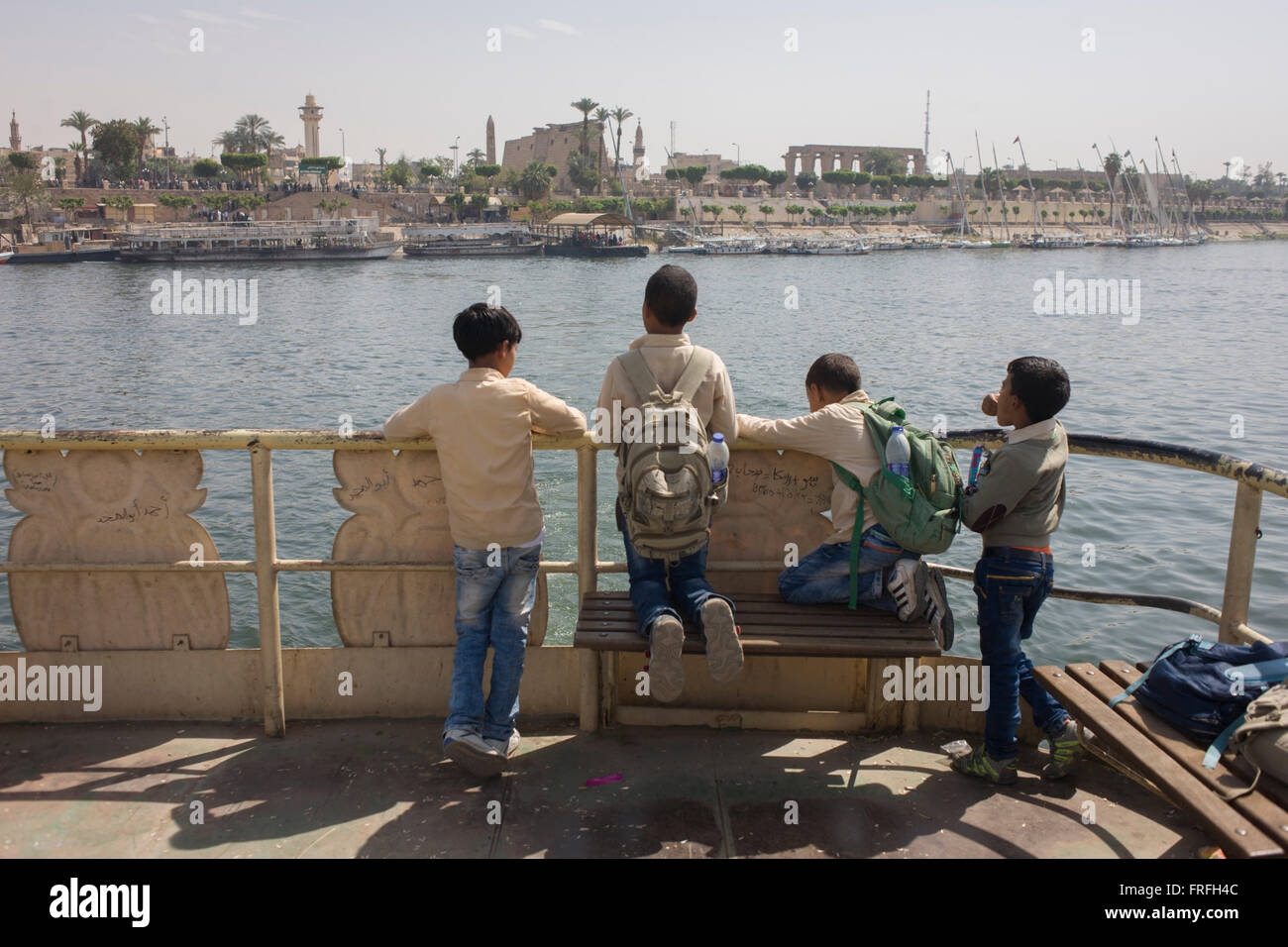 Schoolboys stand on the top deck of the state-run ferry across the River Nile at Luxor, Nile Valley, Egypt. Stock Photo