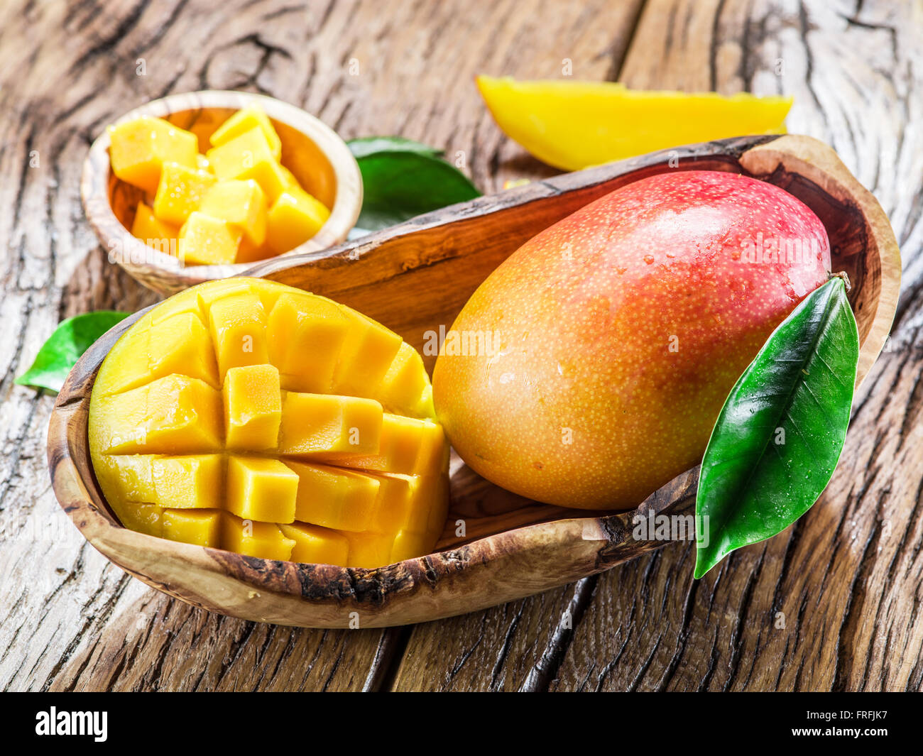 Mango fruit and mango cubes on the wooden table Stock Photo Alamy