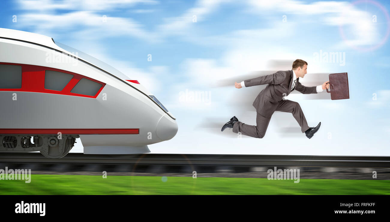 Businessman running away from train Stock Photo Alamy