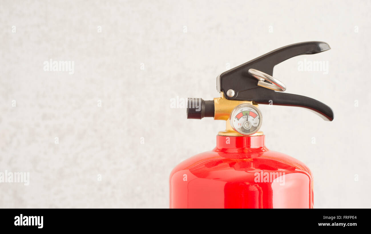 Fire extinguisher close up. Concept of fire prevention, safety equipment and home protection. Stock Photo