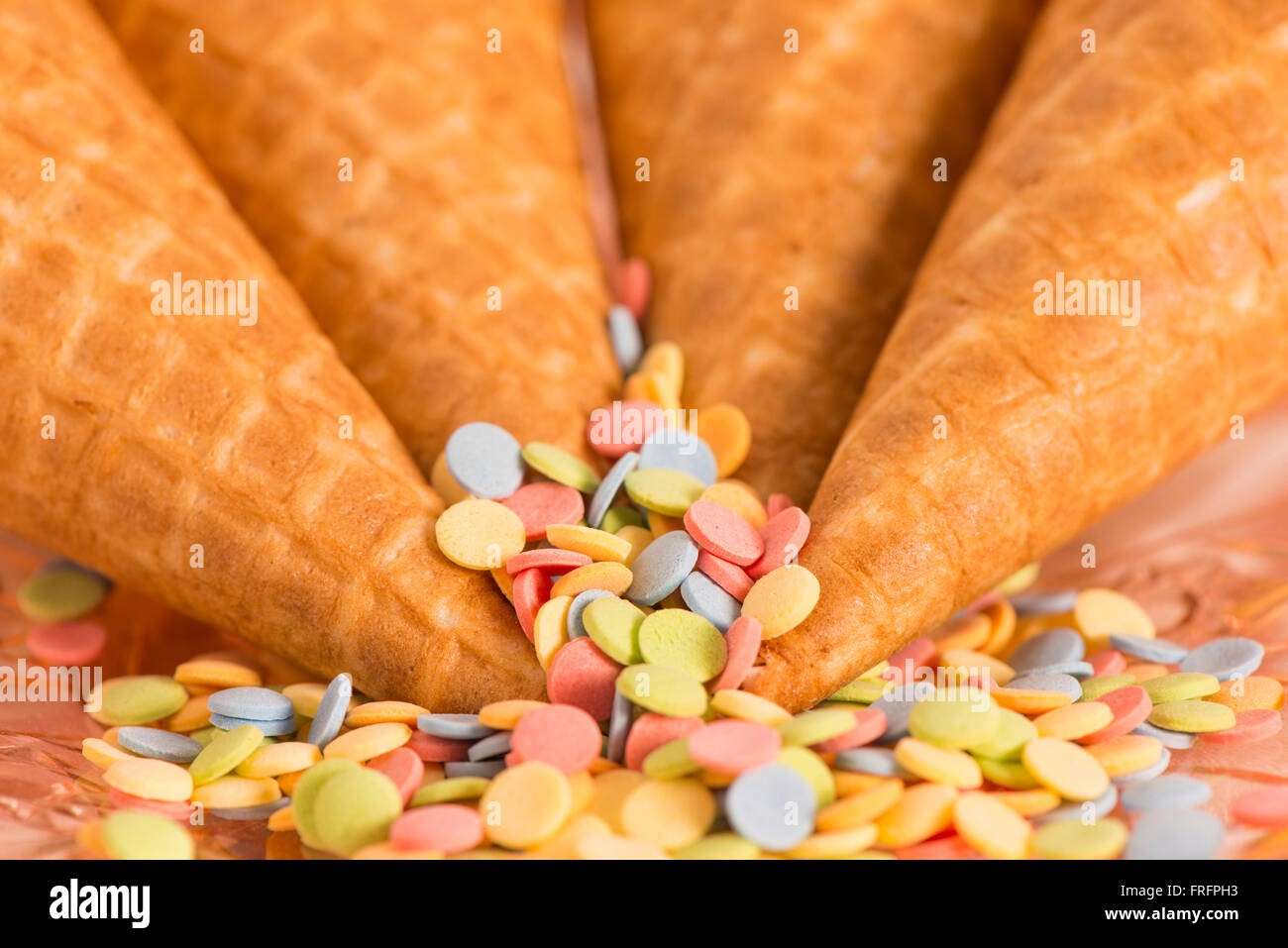 Colorful sugar sprinkles and ice cream cones. Preparation for party or celebration. Concept of birthday styling. Stock Photo