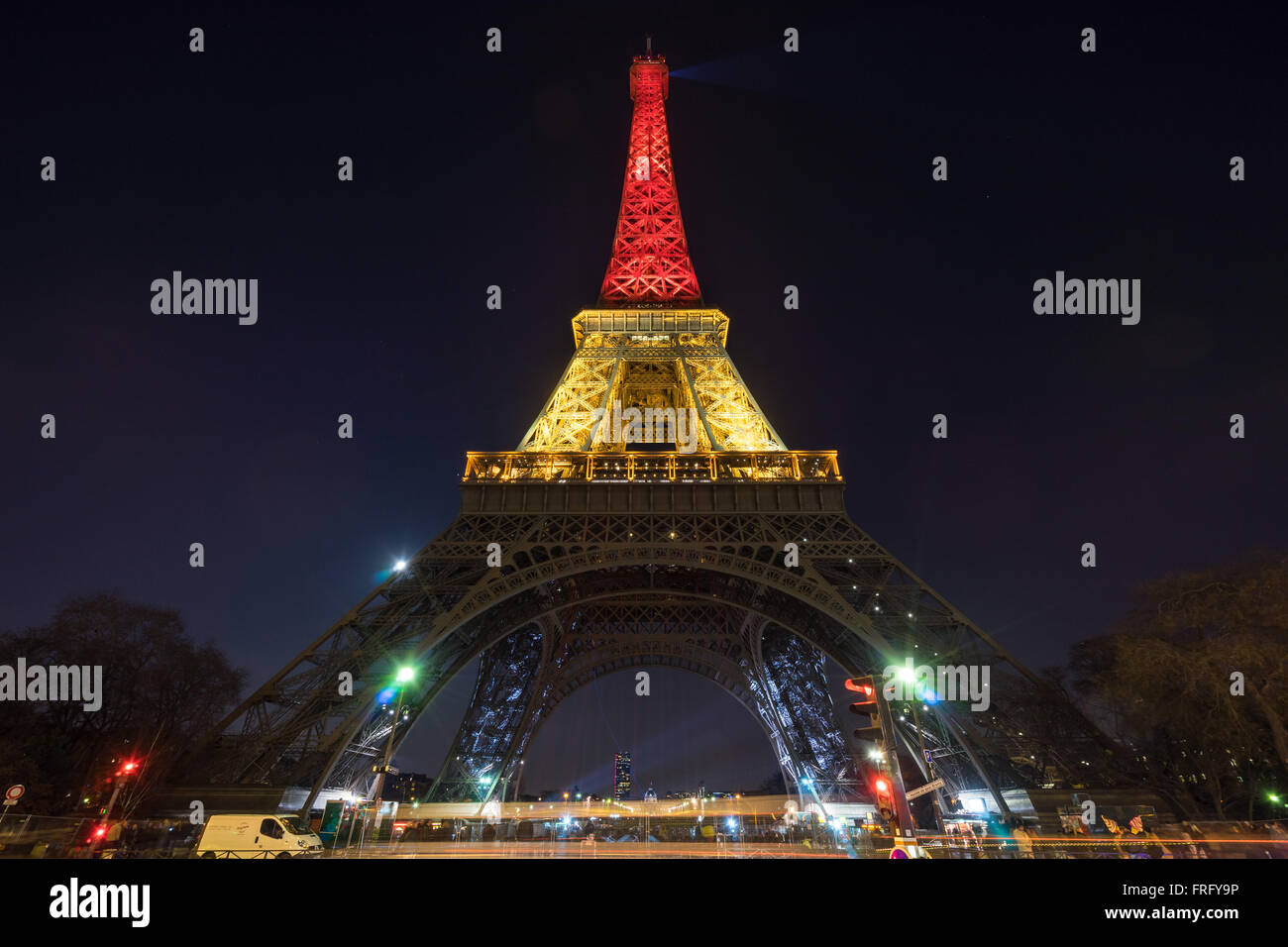 Paris, France. 22nd March, 2016. The Eiffel Tower is lit up with the Belgian flag colors following terror attacks in Brussels, Belgium. Credit:  David BERTHO/Alamy Live News Stock Photo