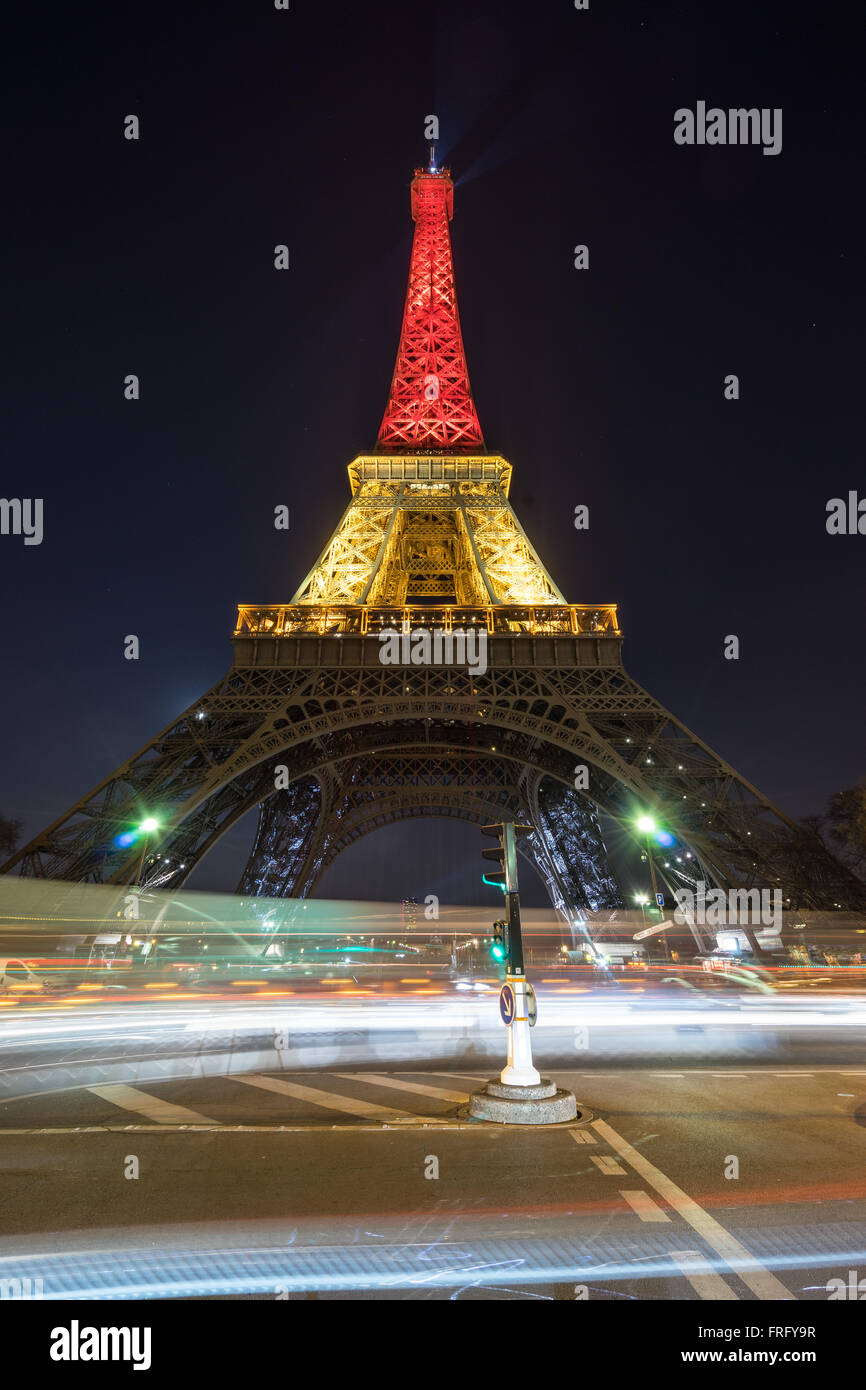 Paris, France. 22nd March, 2016. The Eiffel Tower is lit up with the Belgian flag colors following terror attacks in Brussels, Belgium. Credit:  David BERTHO/Alamy Live News Stock Photo