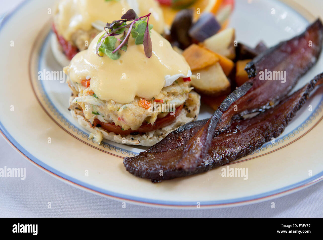 West Palm Beach, Florida, USA. 22nd Mar, 2016. Ocean Bleu Eggs Benedict, crab, grilled heirloom tomatoes, and tricolor potato medley, with a side of Millionaires Bacon. Ocean Bleu was voted best brunch spot in Palm Beach County by Palm Beach Post readers. © Allen Eyestone/The Palm Beach Post/ZUMA Wire/Alamy Live News Stock Photo