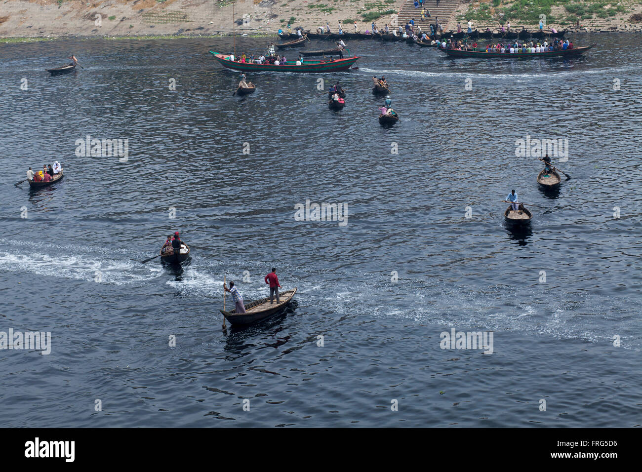 Dhaka, Bangladesh. 21st March, 2016. People ride on boat at the Buriganga river which is full of pitch- black colour water in Dhaka, Bangladesh on March 21, 2016. A large swathe of the Buriganga River which is the lifeline of the capital has turned pitch-black with toxic waste, oil and chemicals flowing into it from industrial units.  Buriganga river, which flows by Dhaka is now one of the most polluted and biologically dead rivers in Bangladesh. Credit:  zakir hossain chowdhury zakir/Alamy Live News Stock Photo