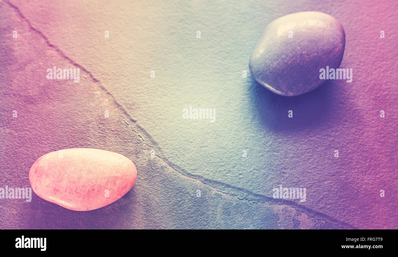 Retro stylized stones on a cracked slate, abstract natural background with shallow depth of field. Stock Photo