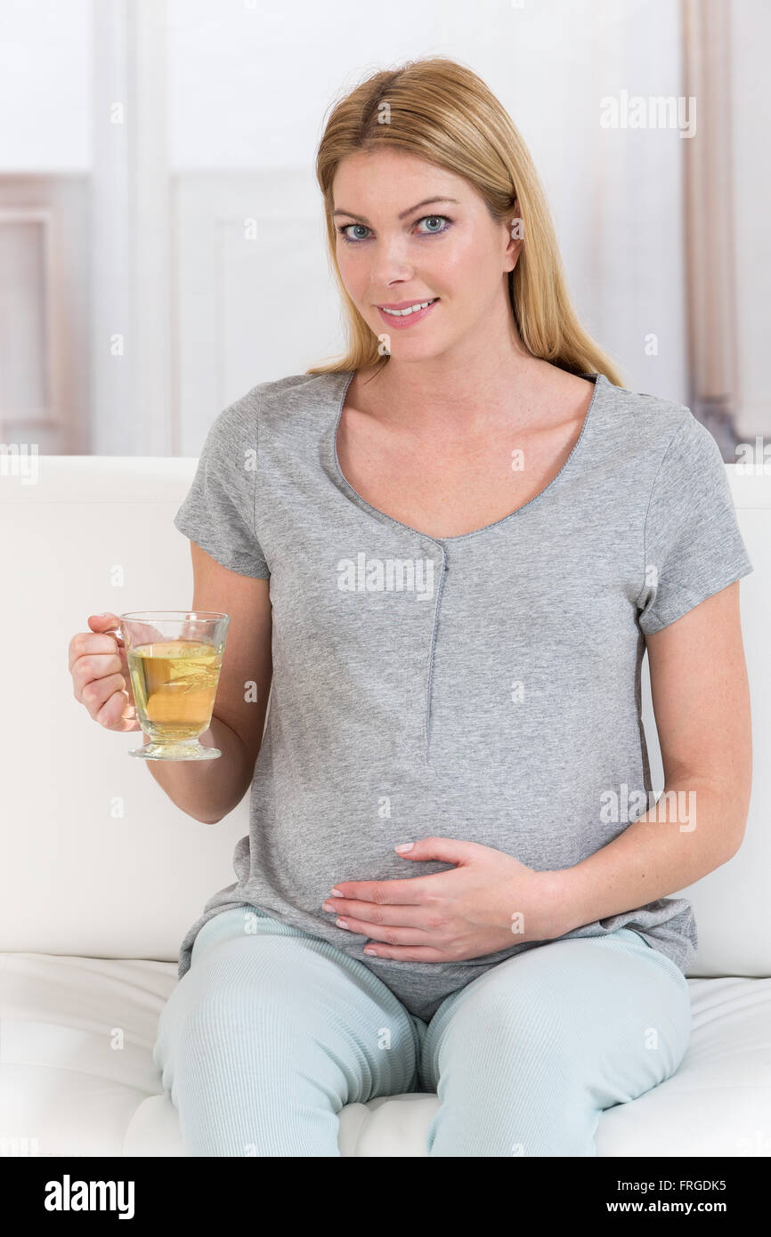 Beautiful happy pregnant woman having a cup of tea Stock Photo - Alamy