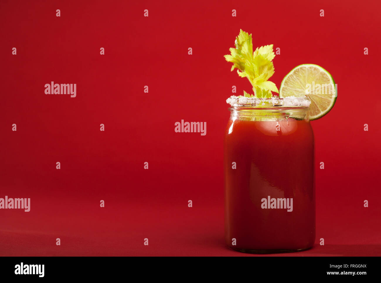 Bloody Mary cocktail on a red background Stock Photo Alamy