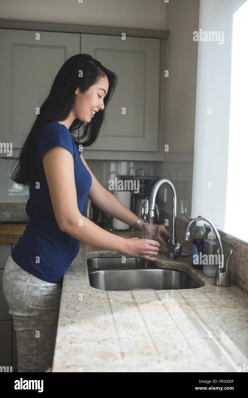 Woman washing her clothes in the kitchen sink domestic chores Stock Photo -  Alamy