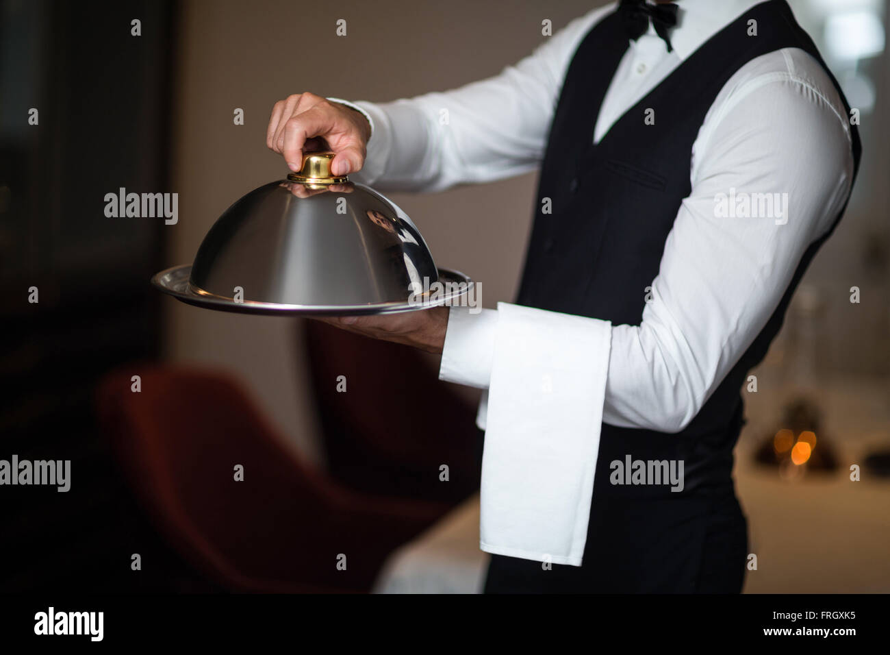 Handsome waiter holding tray Stock Photo Alamy