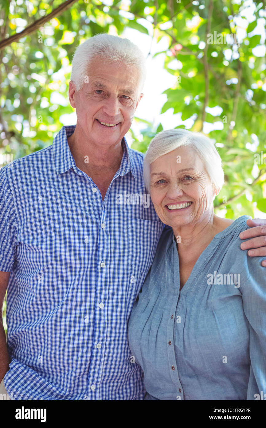 Cheerful senior couple with arm around Stock Photo