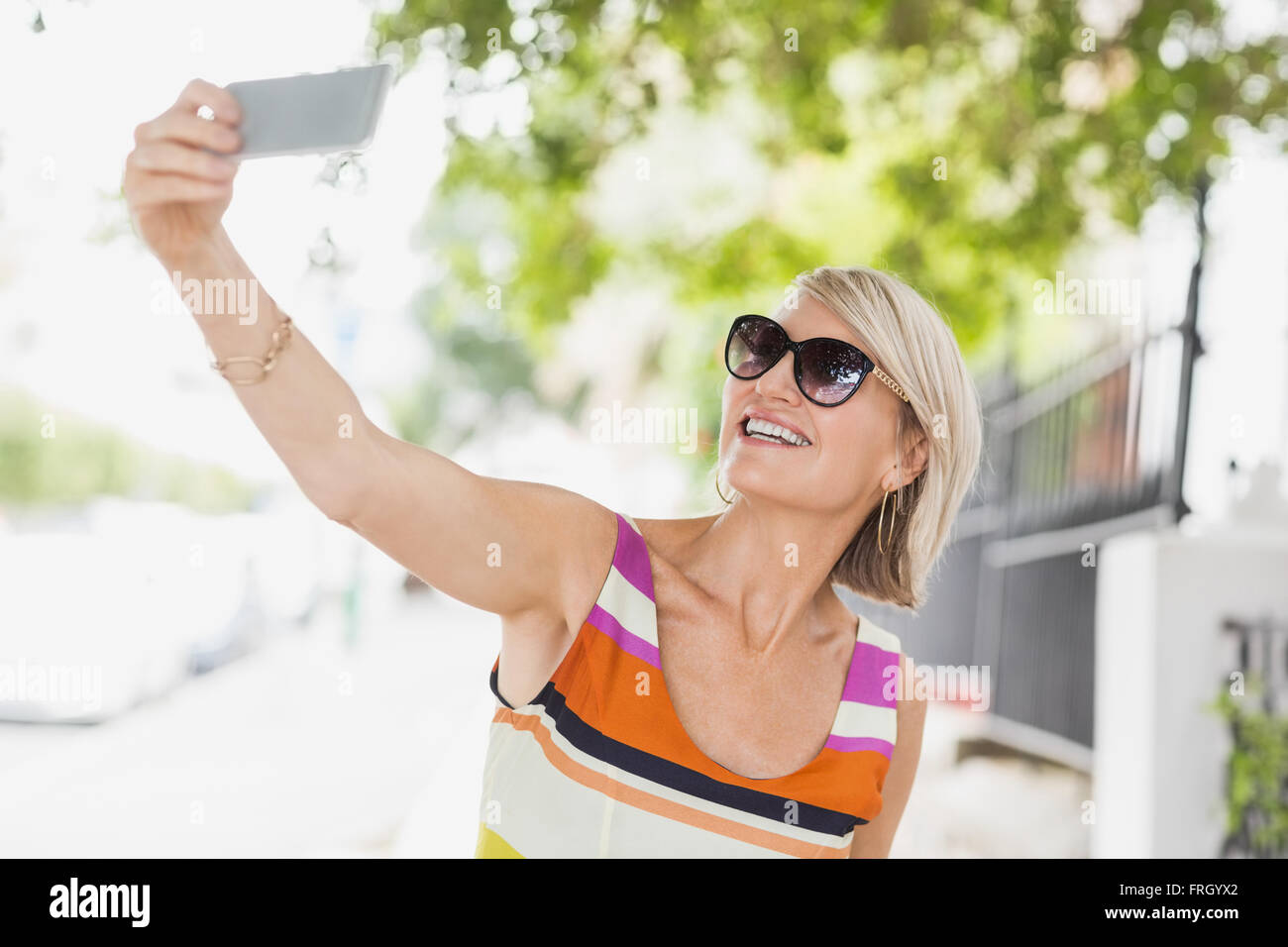 Happy woman taking selfie Stock Photo - Alamy