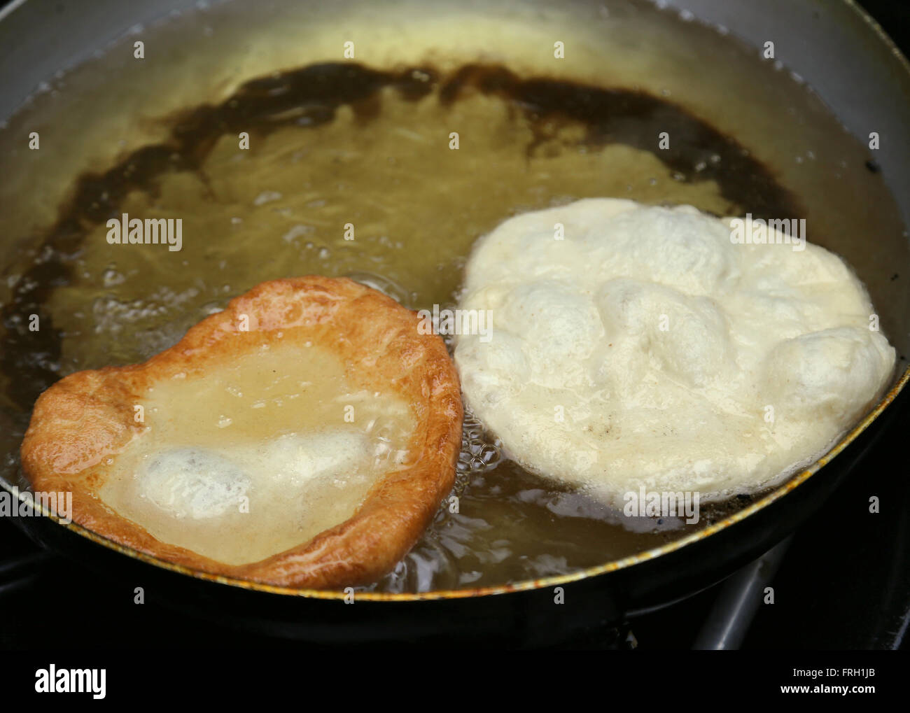 two italian sweet pastry frying in very hot oil Stock Photo Alamy