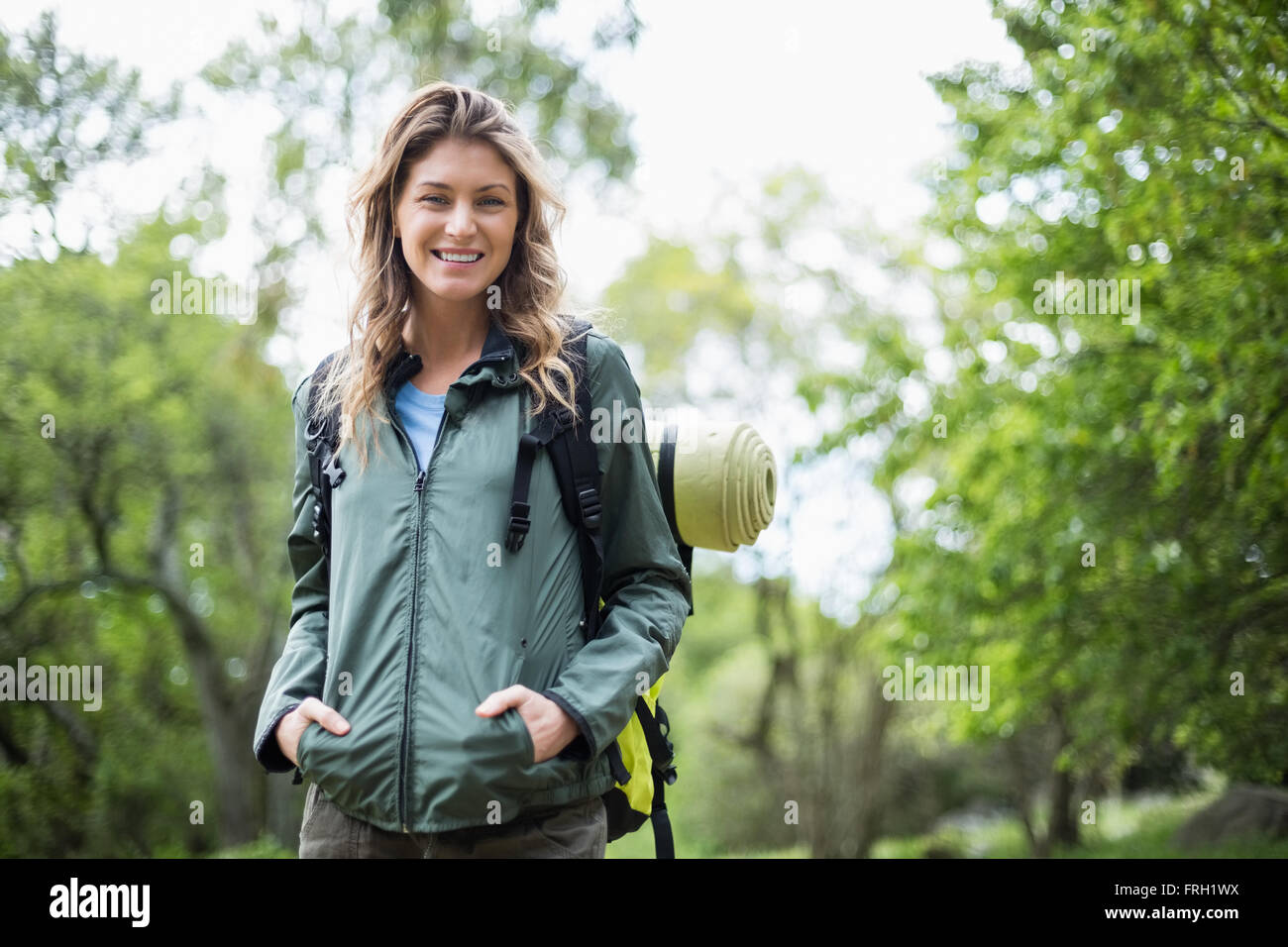 Portrait of woman with hands in pockets Stock Photo