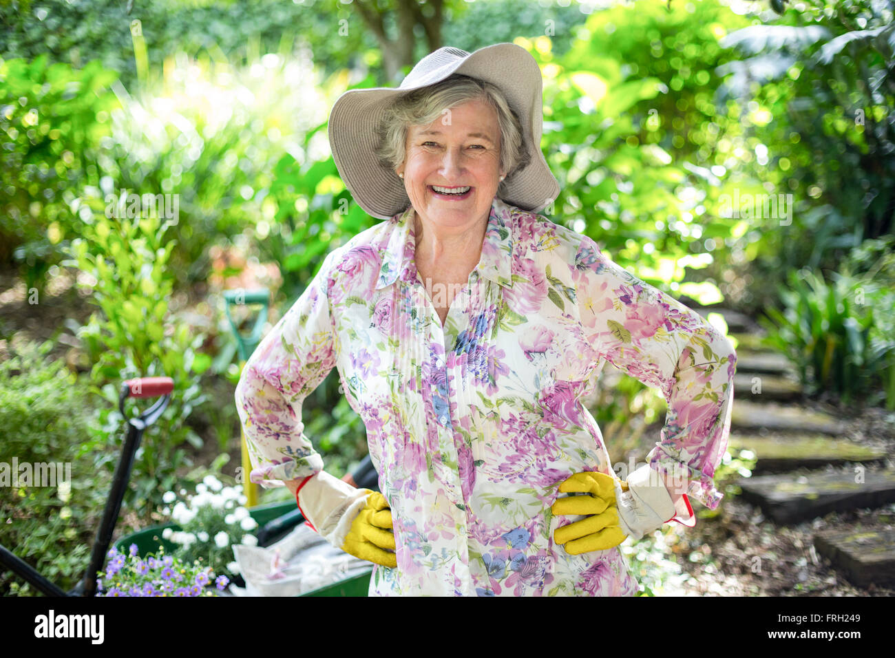 Happy senior woman standing in garden Stock Photo - Alamy