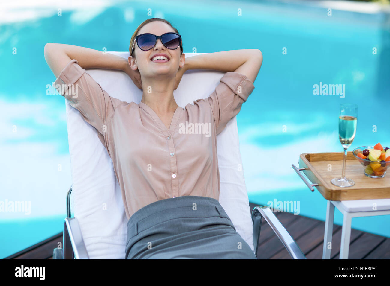 Business woman relaxing on sun lounger Stock Photo - Alamy