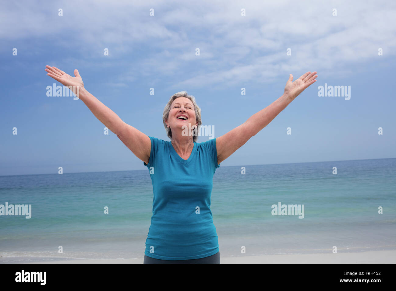 Senior woman standing on beach hi-res stock photography and images - Alamy