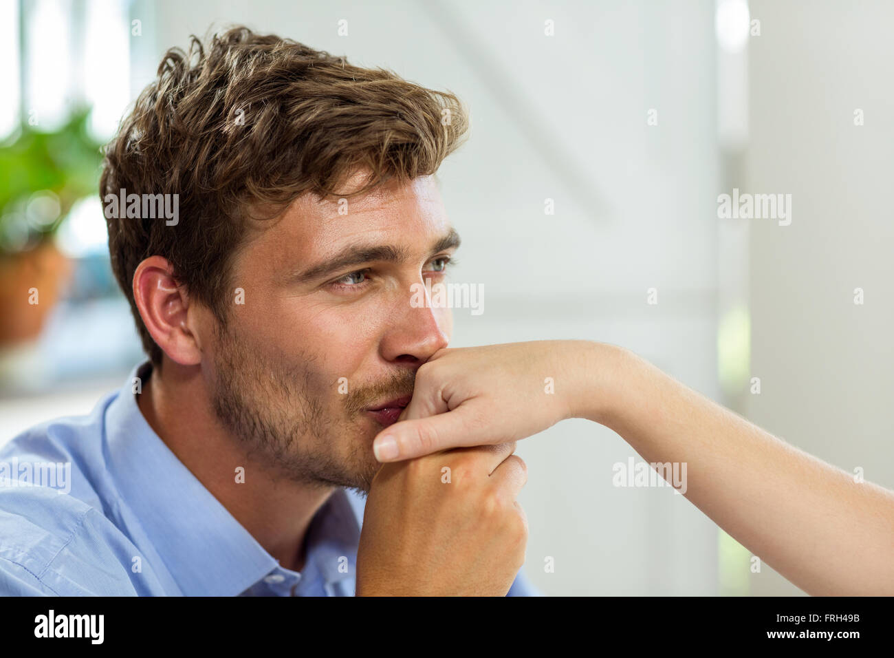 Close-up of man kissing wife hand at home Stock Photo