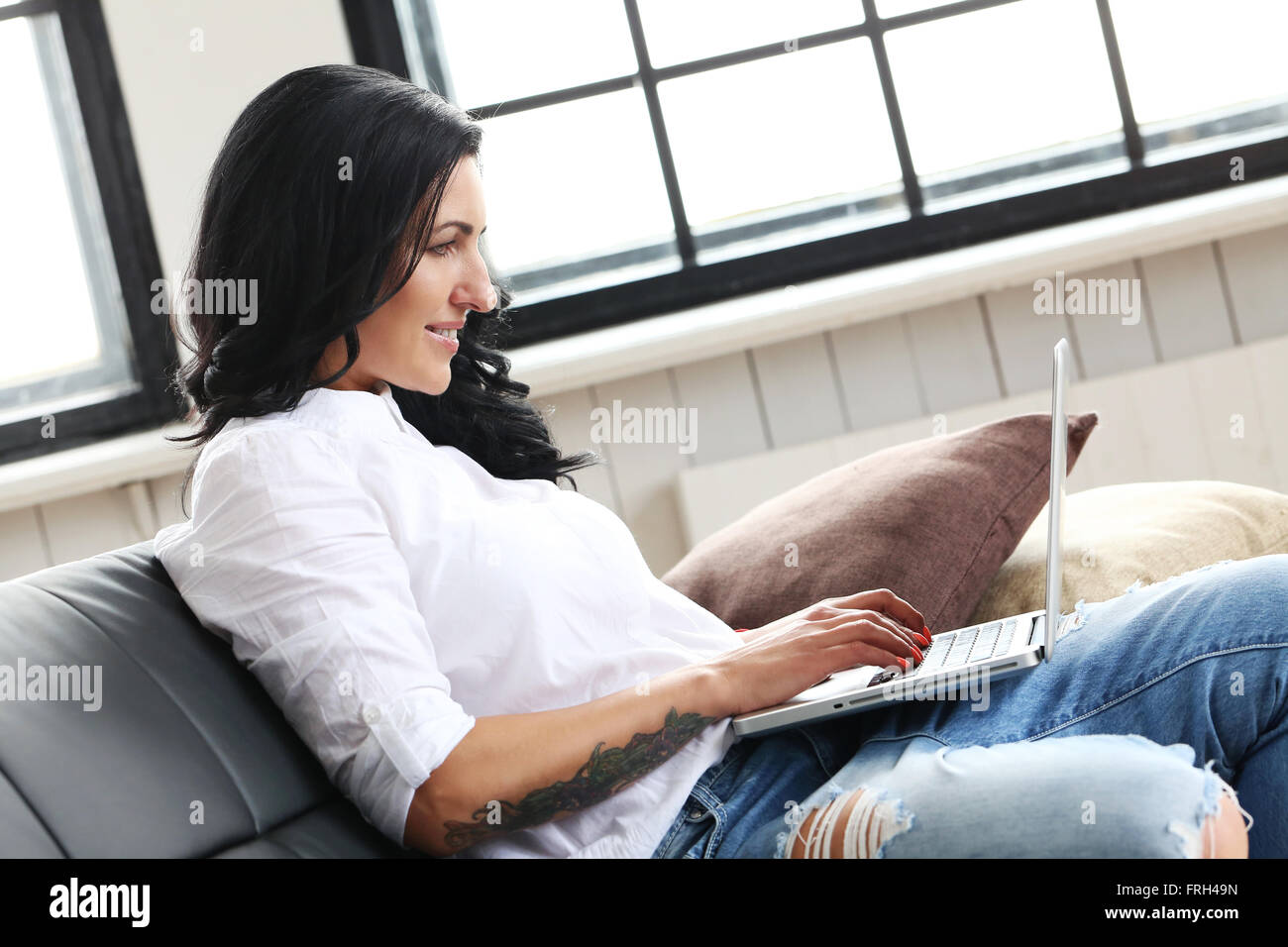 Lovely mature brunette woman typing hi-res stock photography and images ...