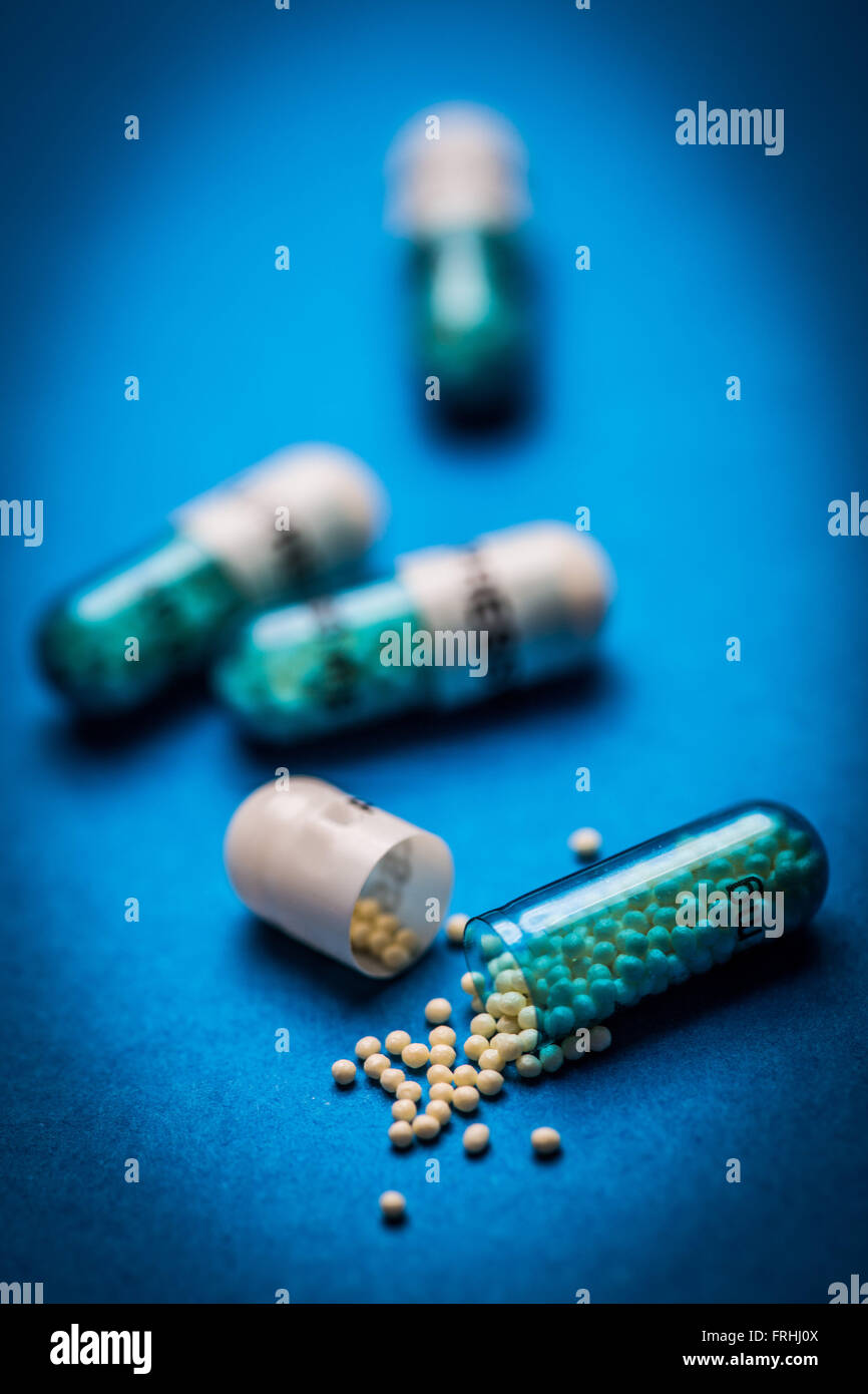 Capsule split in two, containing microgranules Stock Photo Alamy