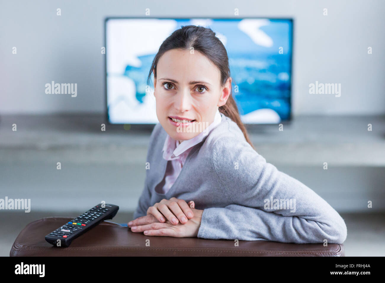 Woman watching TV Stock Photo - Alamy