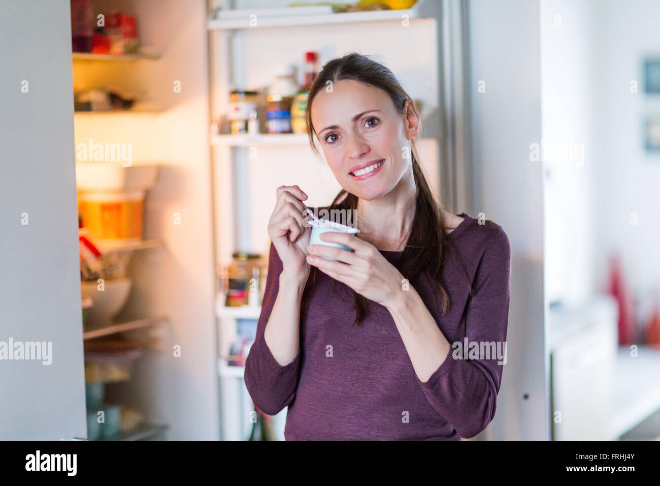 Woman eating yoghurt. Stock Photo
