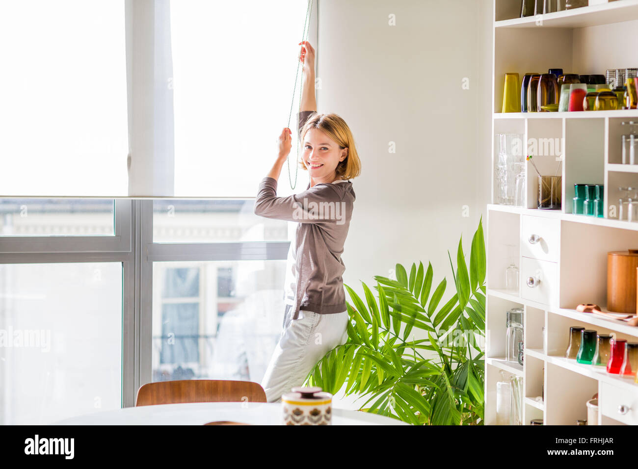Adjusting blind. Stock Photo