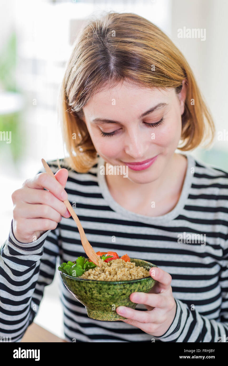 Woman eating a quinoa salad Stock Photo Alamy