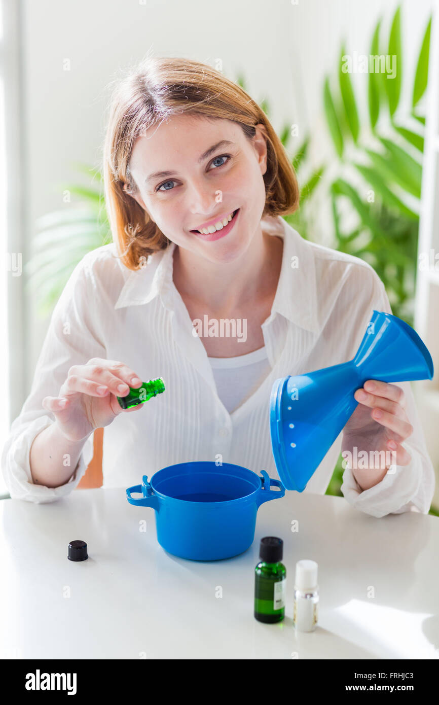 Woman treating a nasal congestion with an inhalation. Stock Photo