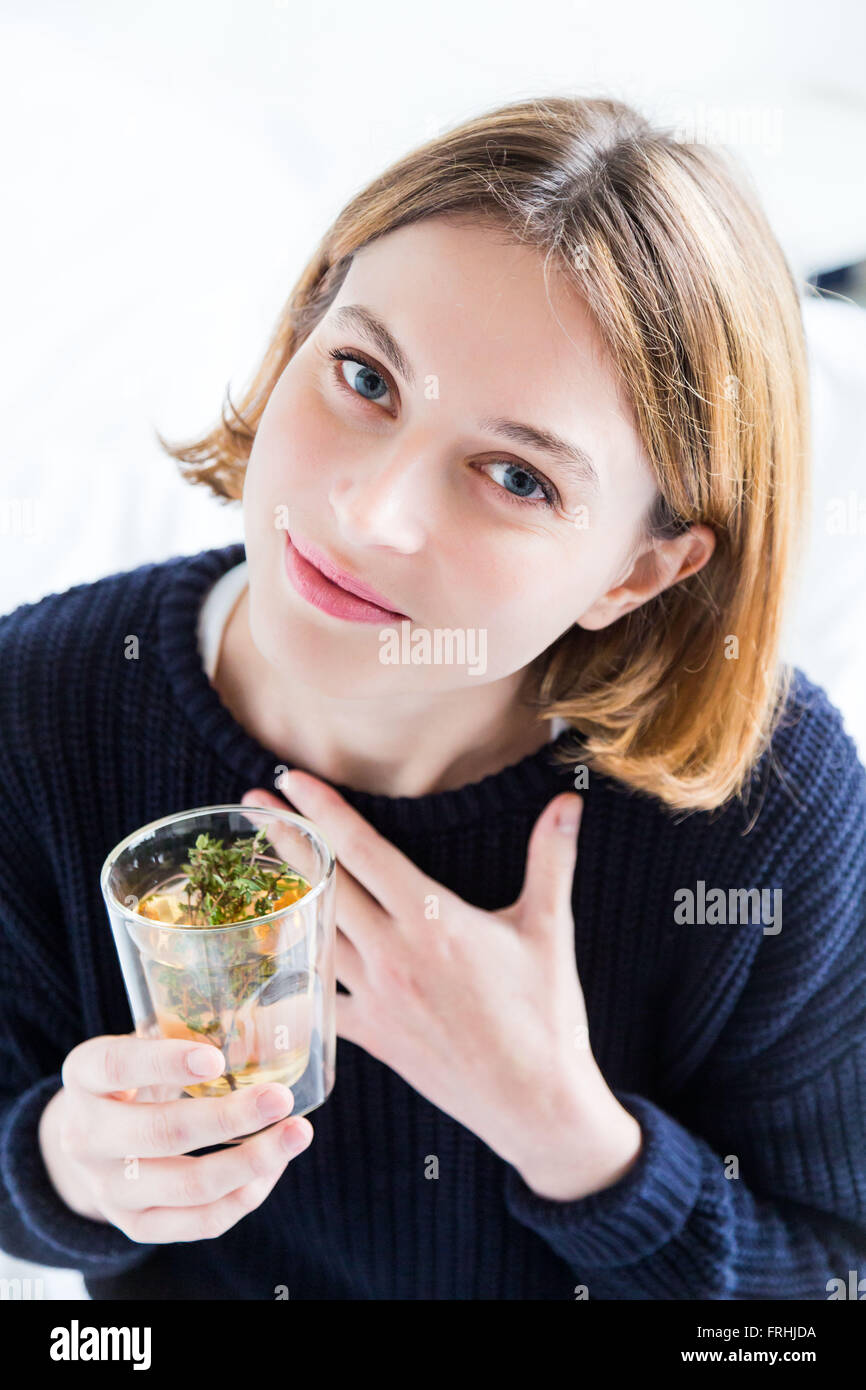 Woman drinking a thyme tea. Stock Photo
