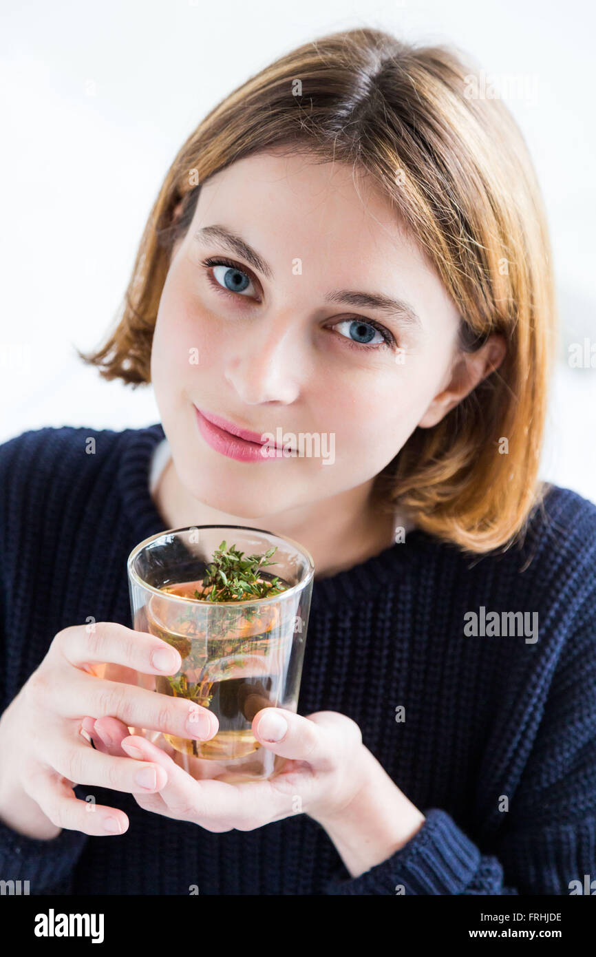 Woman drinking a thyme tea. Stock Photo