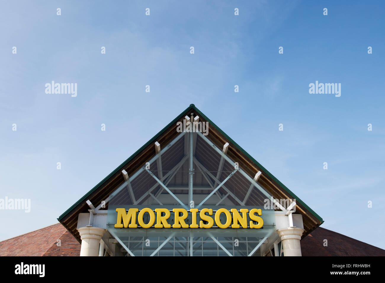 Morrisons supermarket sign against a blue cloudy sky Stock Photo