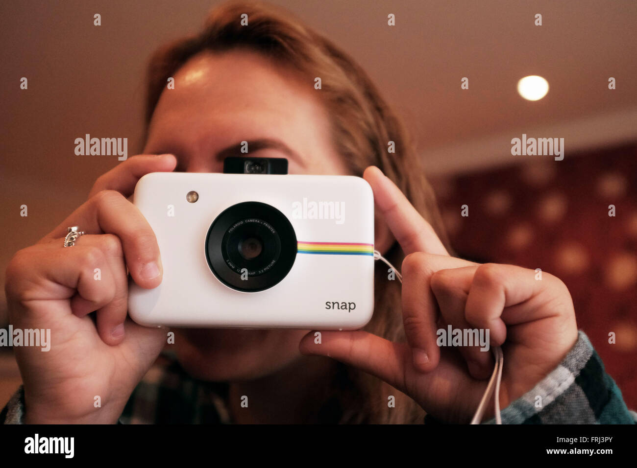 Young Woman Using A Polaroid Snap Camera To Take Instant Print Stock Photo Alamy