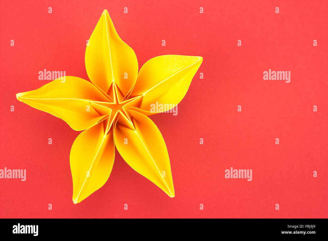 Yellow Paper Origami Flower On Red Background Stock Photo Alamy yellow-paper-origami-flower-on-red-background-stock-photo-alamy