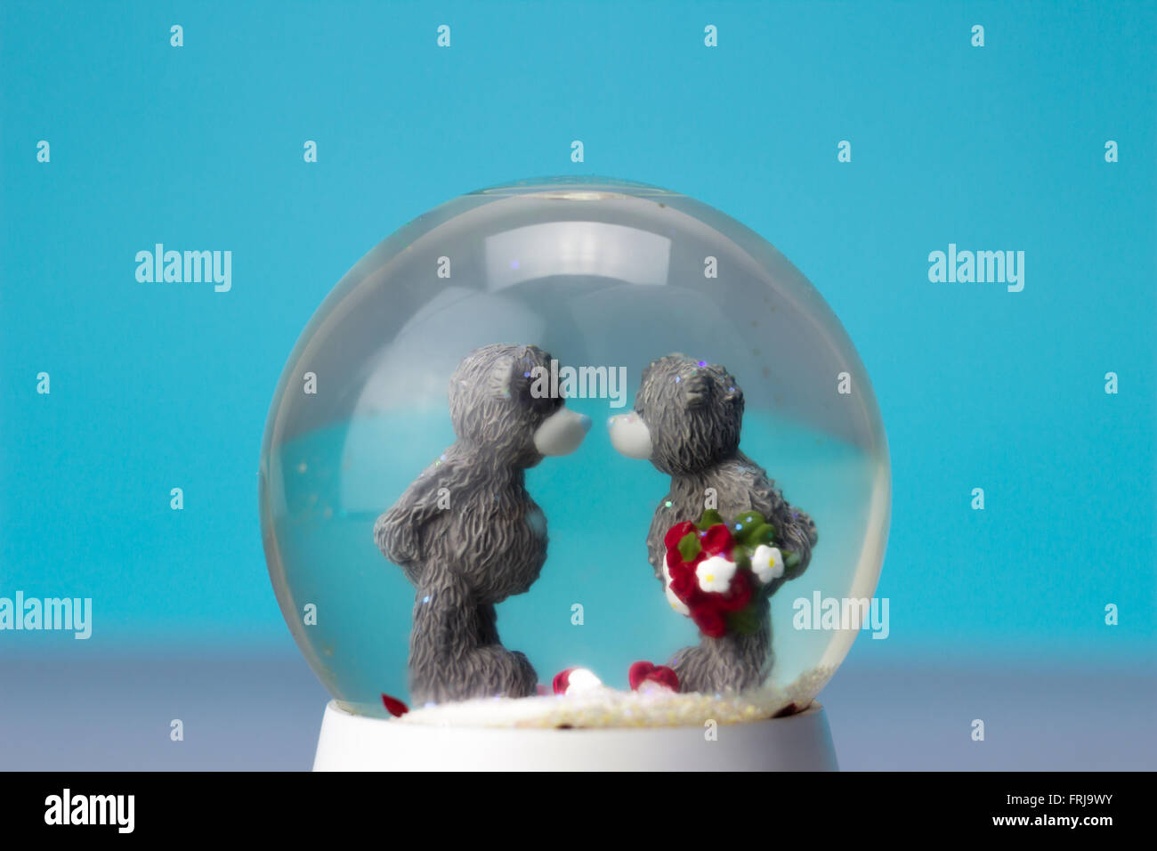 Ceramic bear couple in snow globe Stock Photo