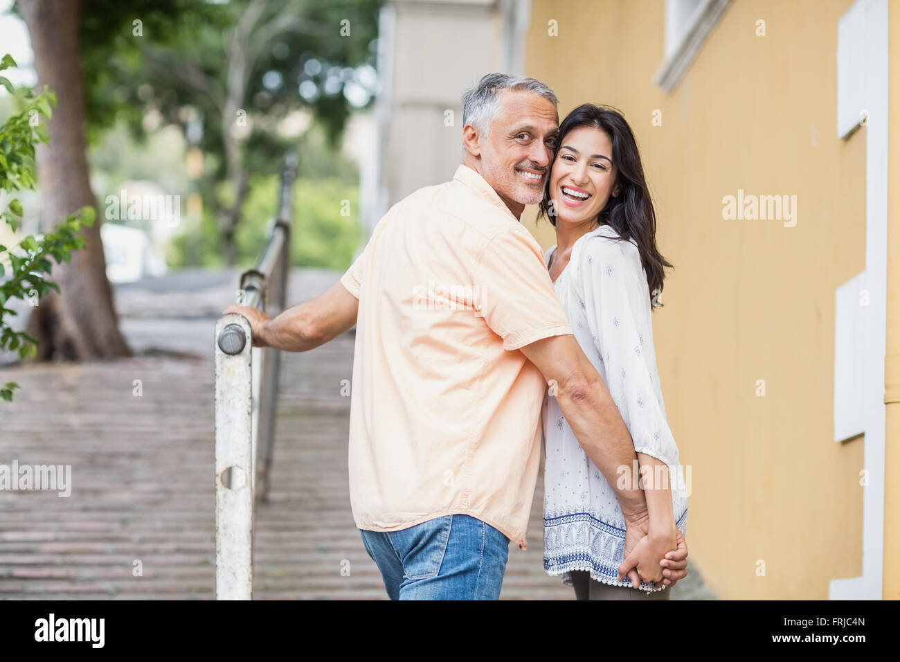 Portrait of happy couple looking over shoulder Stock Photo