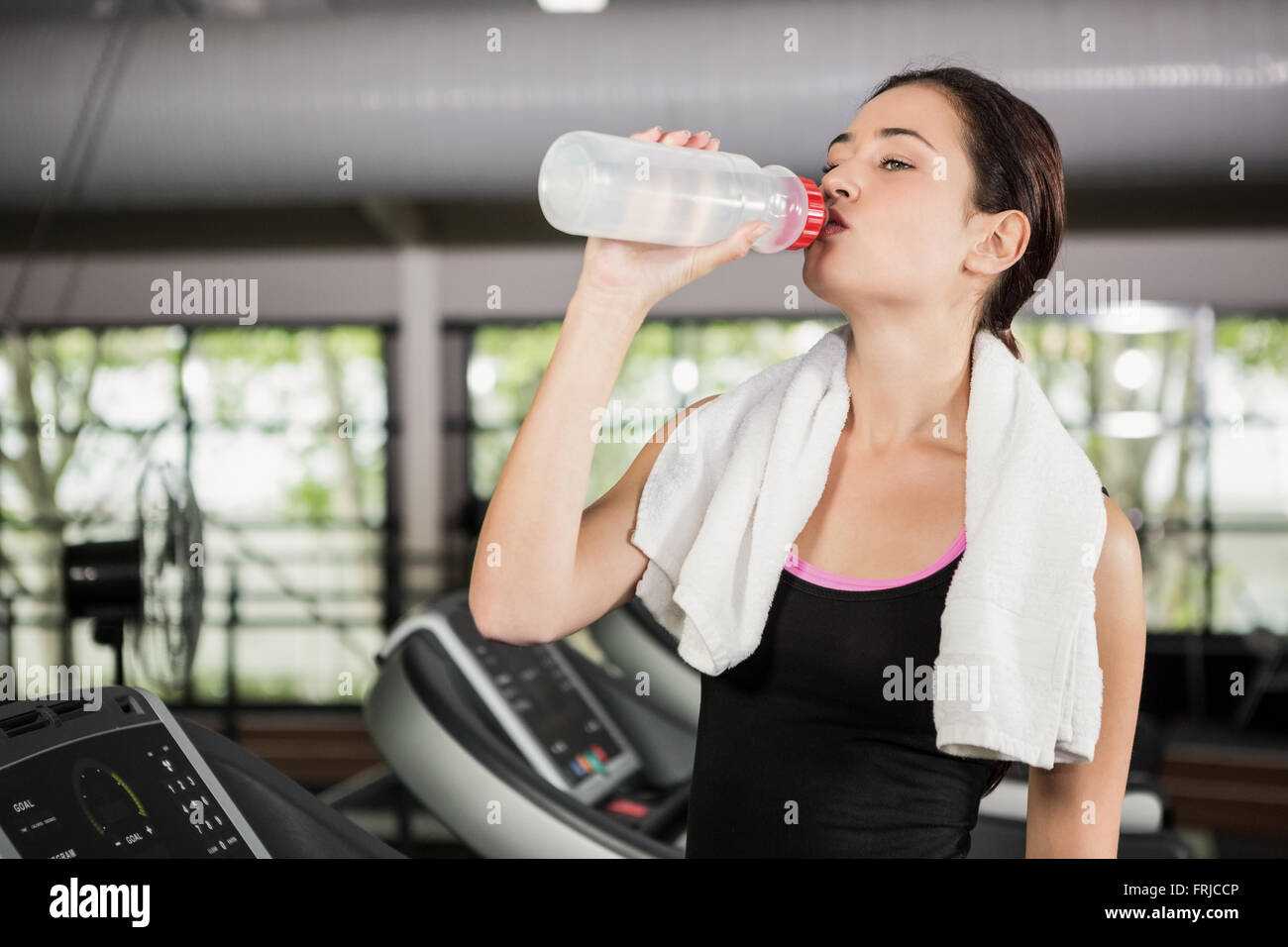 Woman on treadmill drinking water at gym Stock Photo Alamy