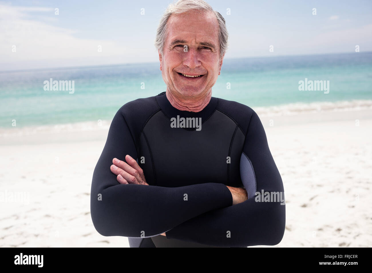 Portrait of happy senior man standing with arms crossed Stock Photo - Alamy