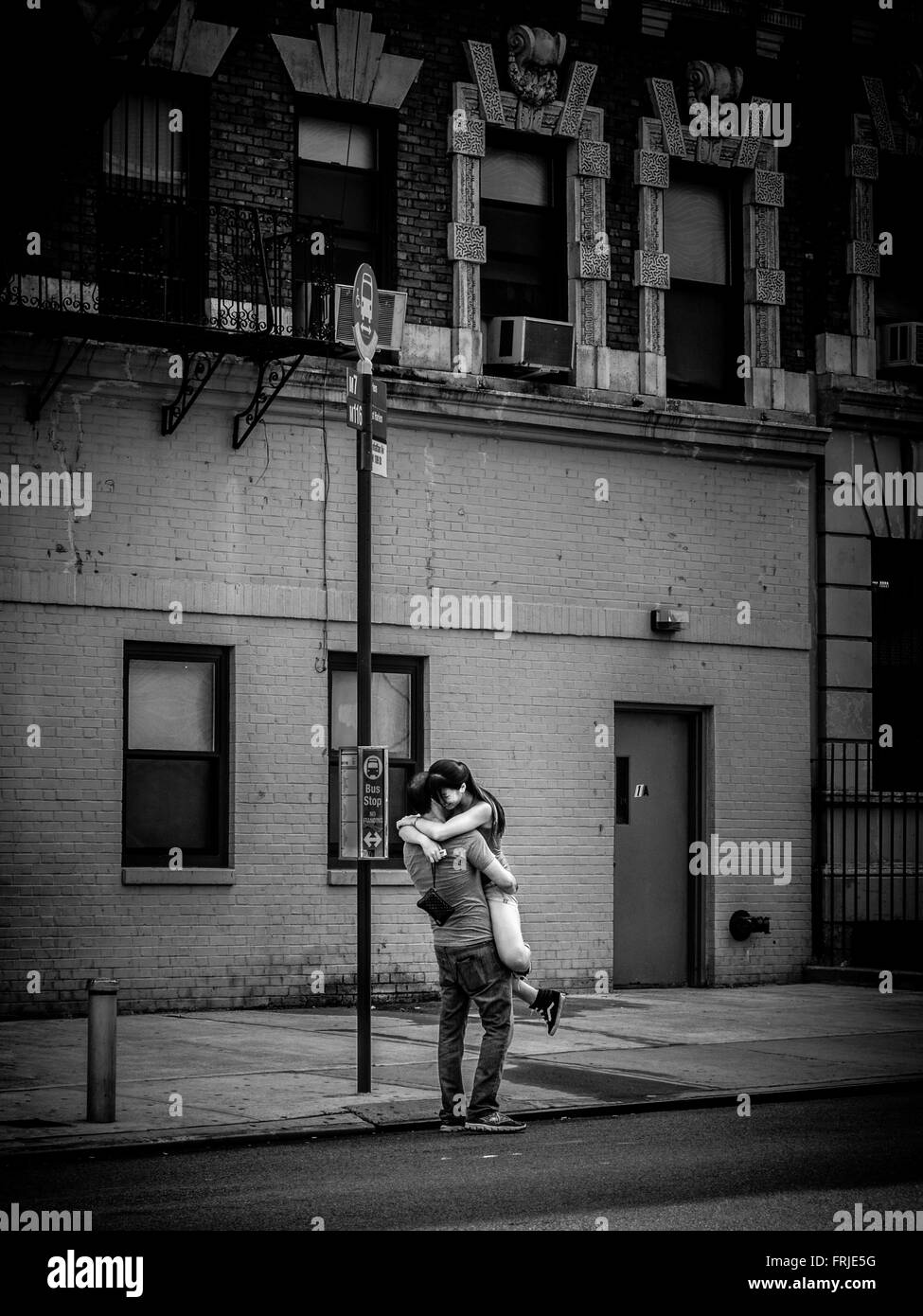 Young couple embracing in street, New York City, USA. Stock Photo