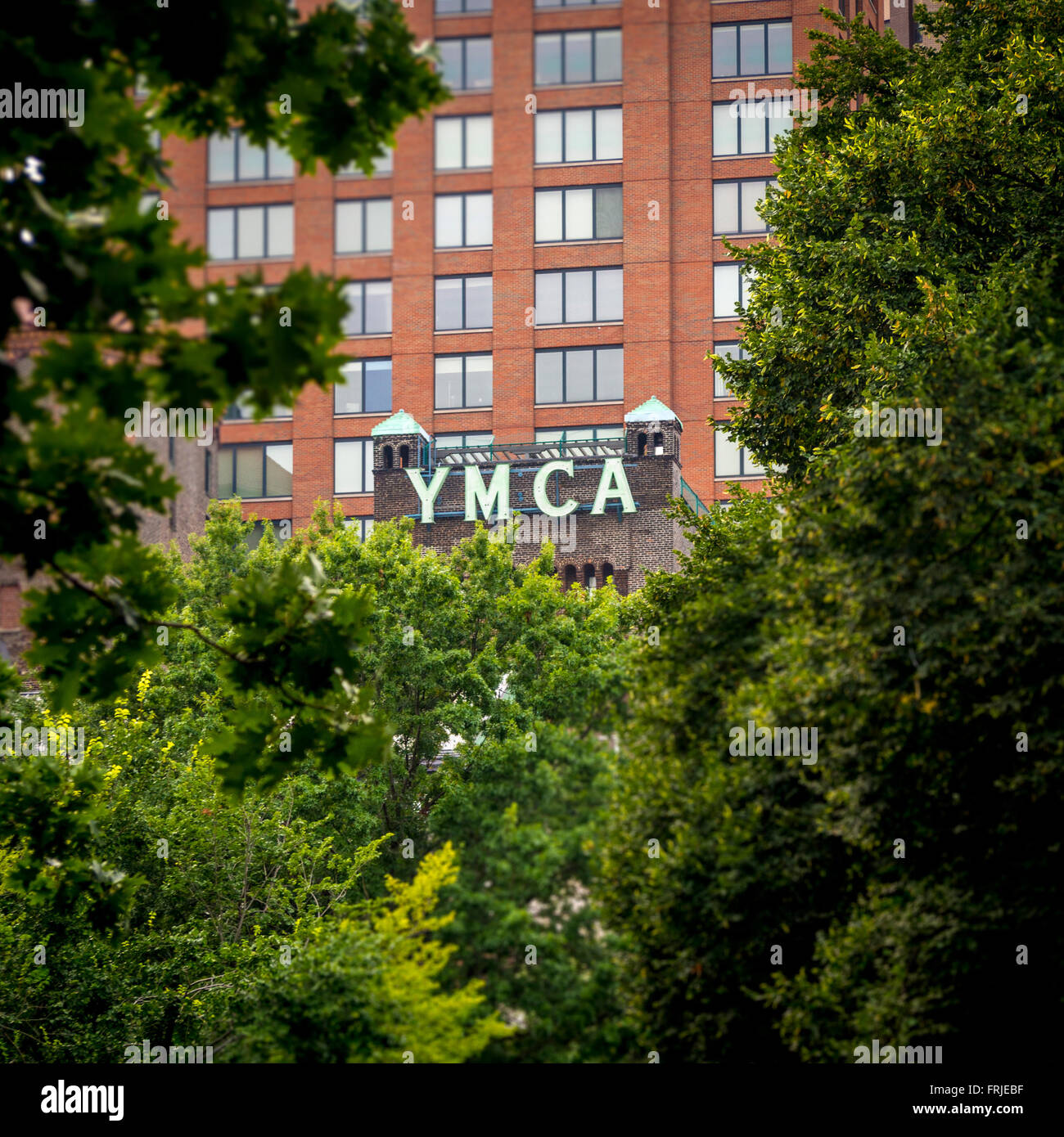 West side YMCA building seen through trees in Central Park, New York City, USA. Stock Photo