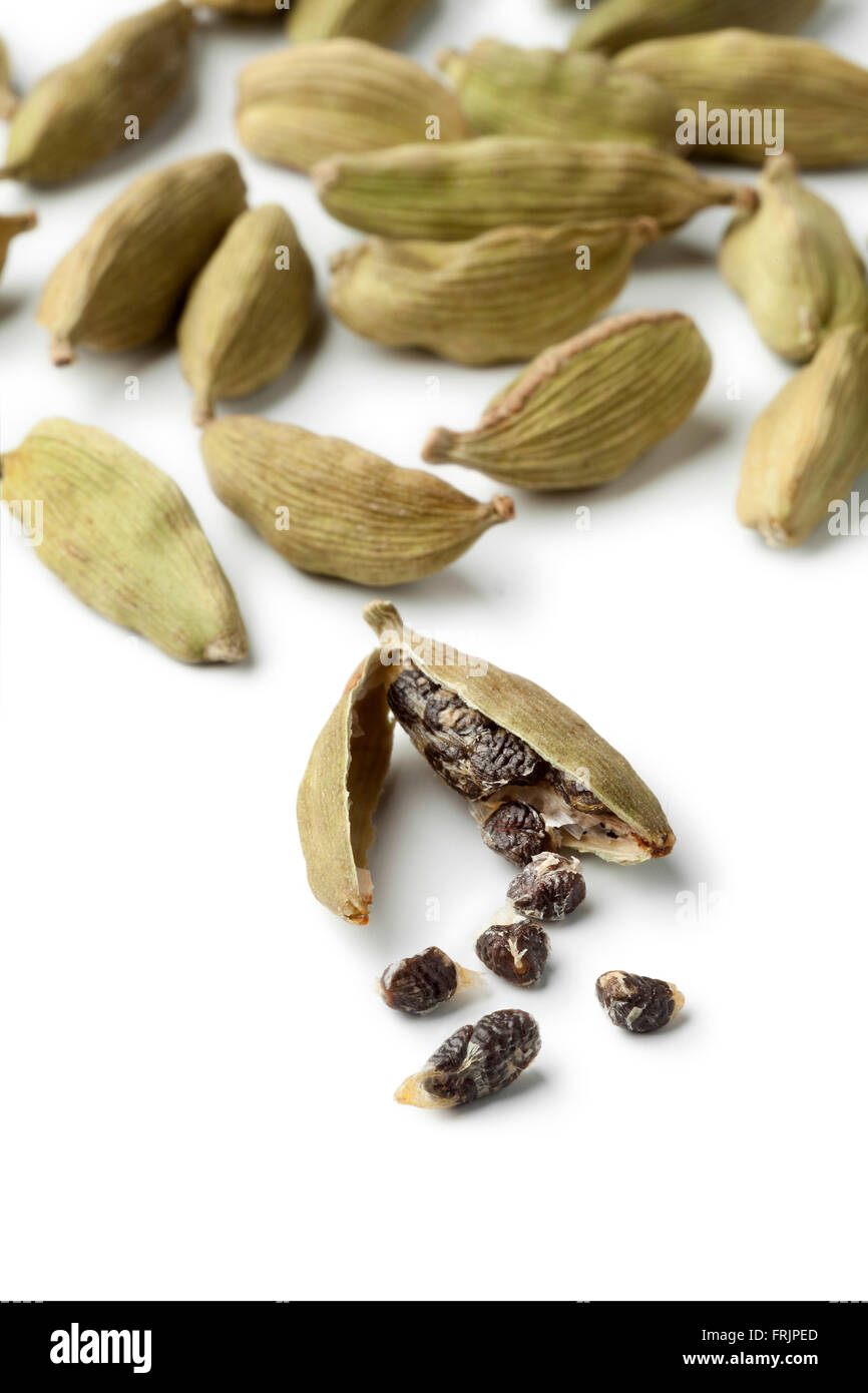 Green cardamom pods and seeds close up on white background Stock Photo