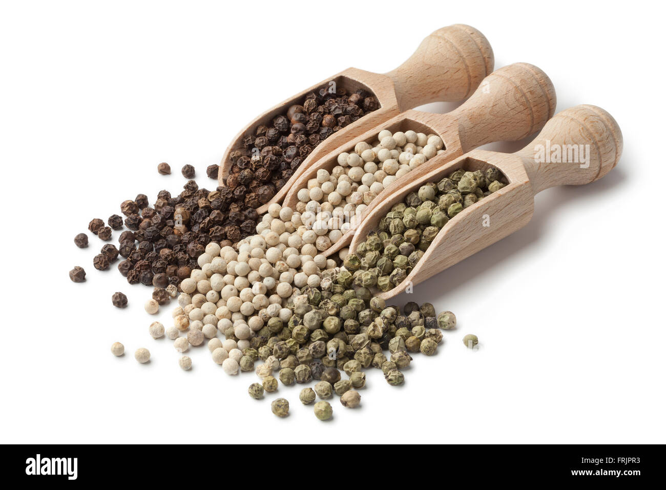 Wooden scoops with black, white and green peppercorns on white background Stock Photo